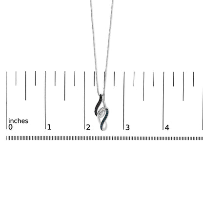White metal necklace with a pendant shown on a scale. The pendant features an abstract twist design with three white gemstones set in prongs at the center, bordered by rows of blue and black gemstones in shared prong settings. Photo taken from a front angle.