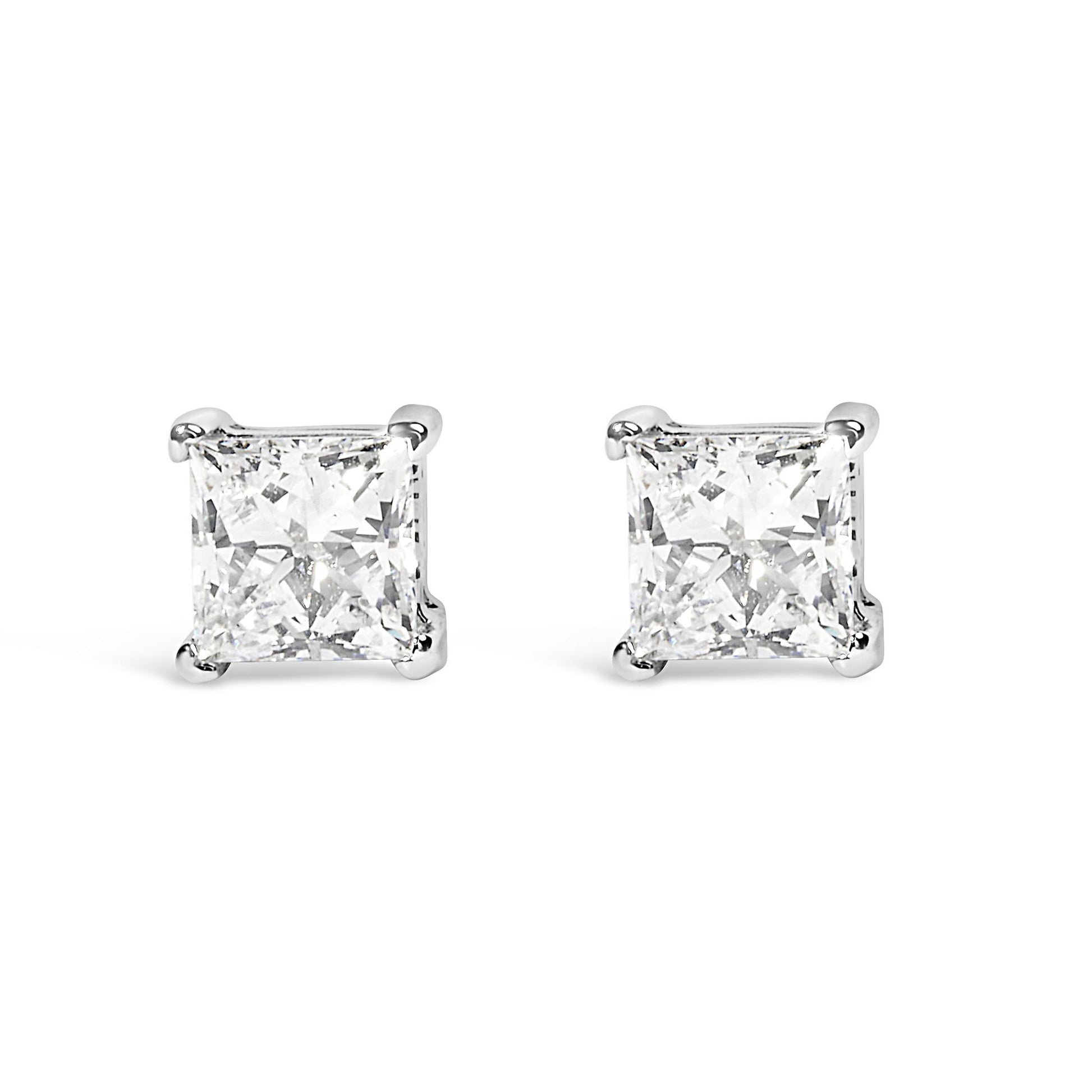 Front angle view of white metal stud earrings with princess shape white gemstones in prong settings.