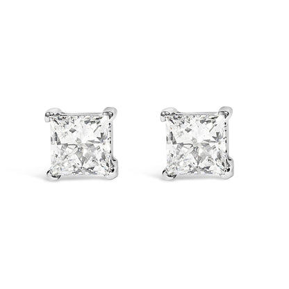 Front angle view of white metal stud earrings with princess shape white gemstones in prong settings.