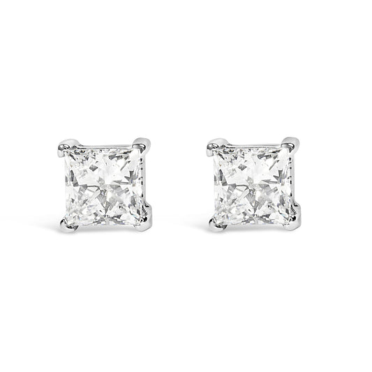 Front angle view of white metal stud earrings with princess shape white gemstones in prong settings.