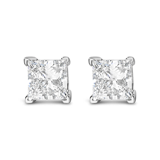 Front angle view of white metal earrings with square-shaped white gemstones in four-prong settings.