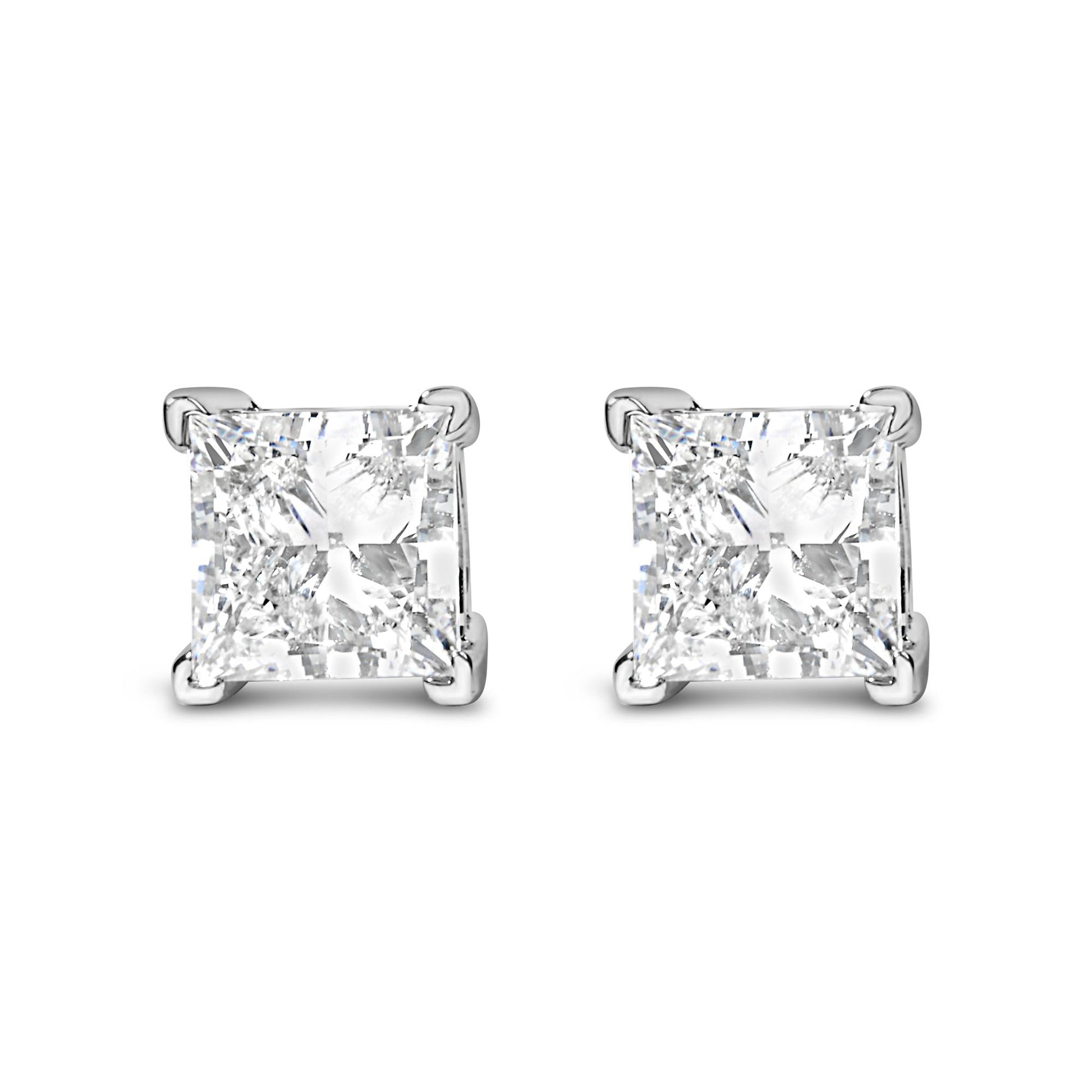 Front angle view of white metal earrings with square-shaped white gemstones in four-prong settings.