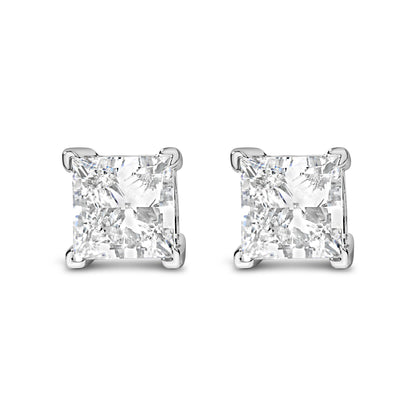 Front angle view of white metal earrings with square-shaped white gemstones in four-prong settings.