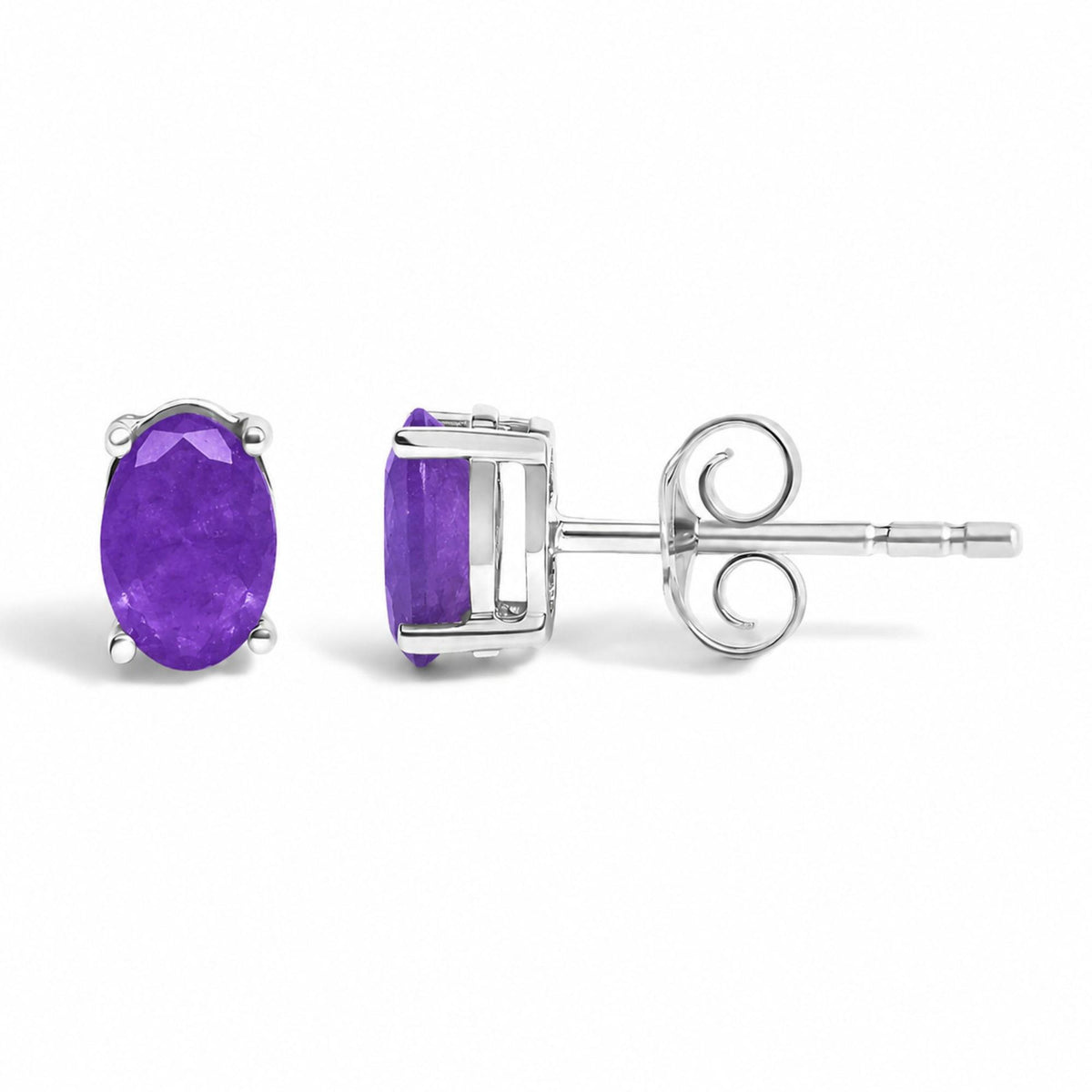 Close-up front and side views of a pair of white metal stud earrings, each featuring an oval-shaped purple gemstone in a four-prong setting, shown on a white background.