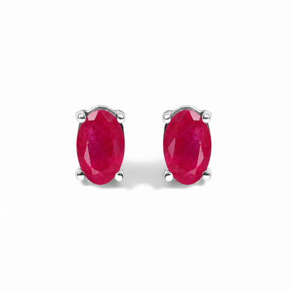 Front view of sterling silver 5x3mm natural oval gemstone solitaire stud earrings with red stones on white background