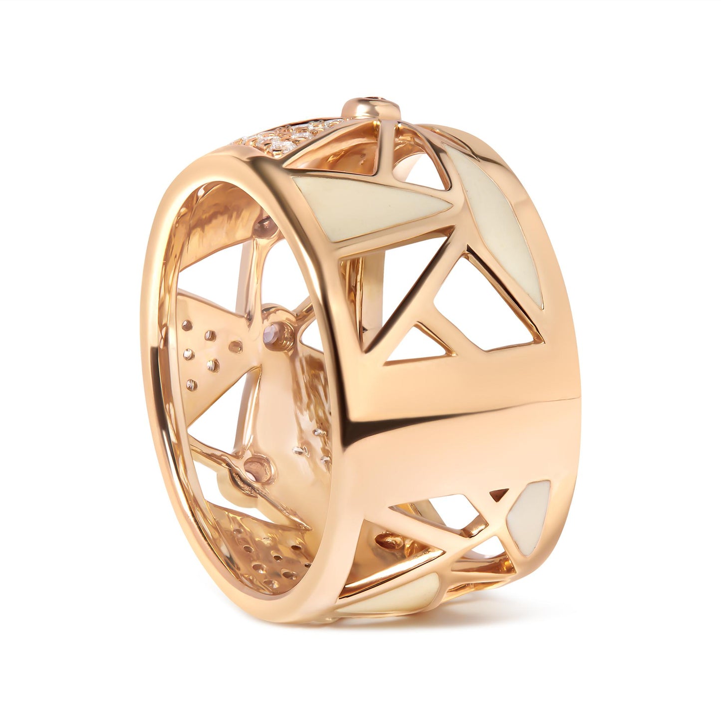 Rose metal wide ring with geometric cutouts and inlaid white enamel sections, shot at an angle showing front and side.