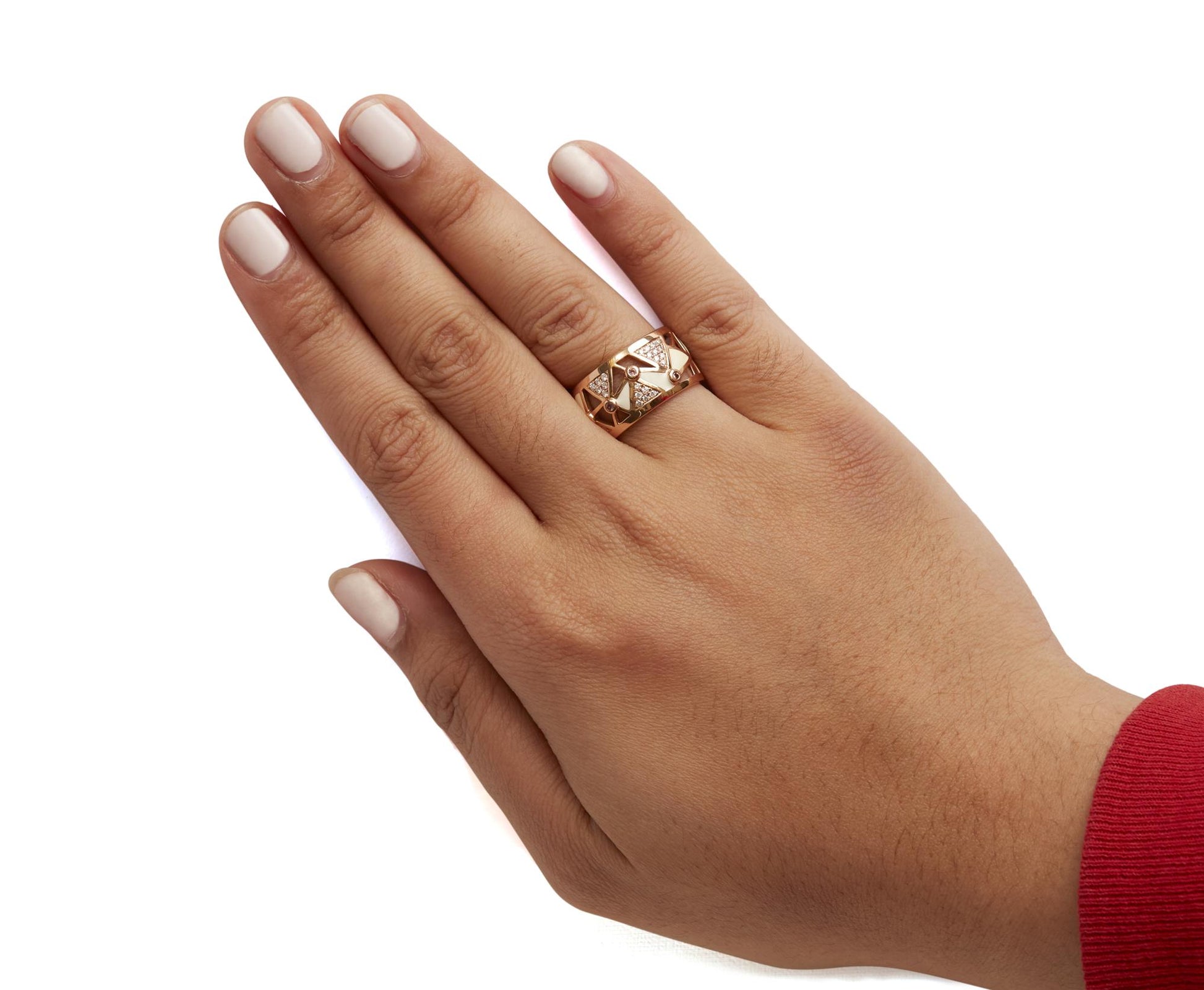 Rose metal ring with white gemstones in pave setting and pink gemstones in bezel setting, shown worn on a model's hand from a top angle.