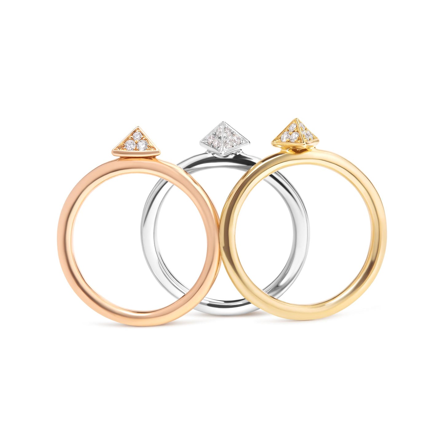 Front-facing shot of three rings in yellow, white, and rose metal colors, each featuring a triangular top with white round pave-set gemstones.
