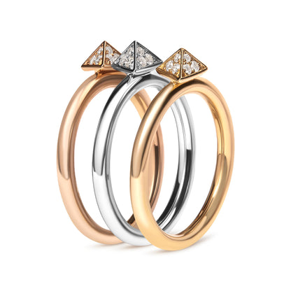 Three rings in yellow, white, and rose metal colors shown from a close-up side angle, each featuring a pyramid-shaped head adorned with multiple white gemstones in a pave setting.