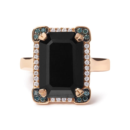 Front-facing rose metal ring with a large black emerald-shaped gemstone in a four-prong setting, surrounded by white round pave-set gemstones and clusters of blue round pave-set gemstones in each corner.