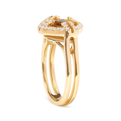 Yellow metal ring with a marquise shaped yellow gemstone in prong setting surrounded by round white gemstones in pave setting, shown from a side angle.