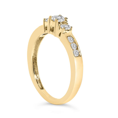 Yellow metal ring shown in a side angle with a three white gemstones in four-prong settings across the top and additional white gemstones set in a channel setting on the band side.