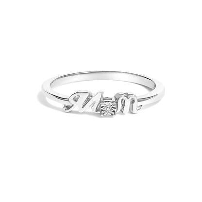 Front angle of a white metal ring with the word 'Mom' in cursive lettering, featuring a round white gemstone in a prong setting between the letters.