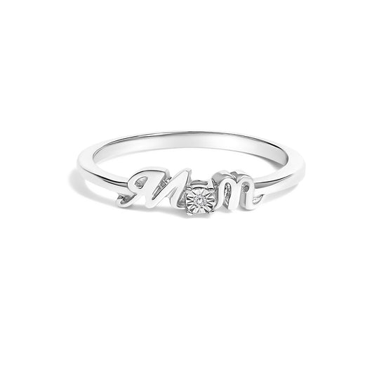 Front angle of a white metal ring with the word 'Mom' in cursive lettering, featuring a round white gemstone in a prong setting between the letters.