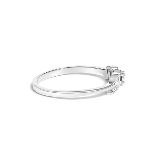 Side angle of a white metal ring featuring one round white gemstone in a prong setting.