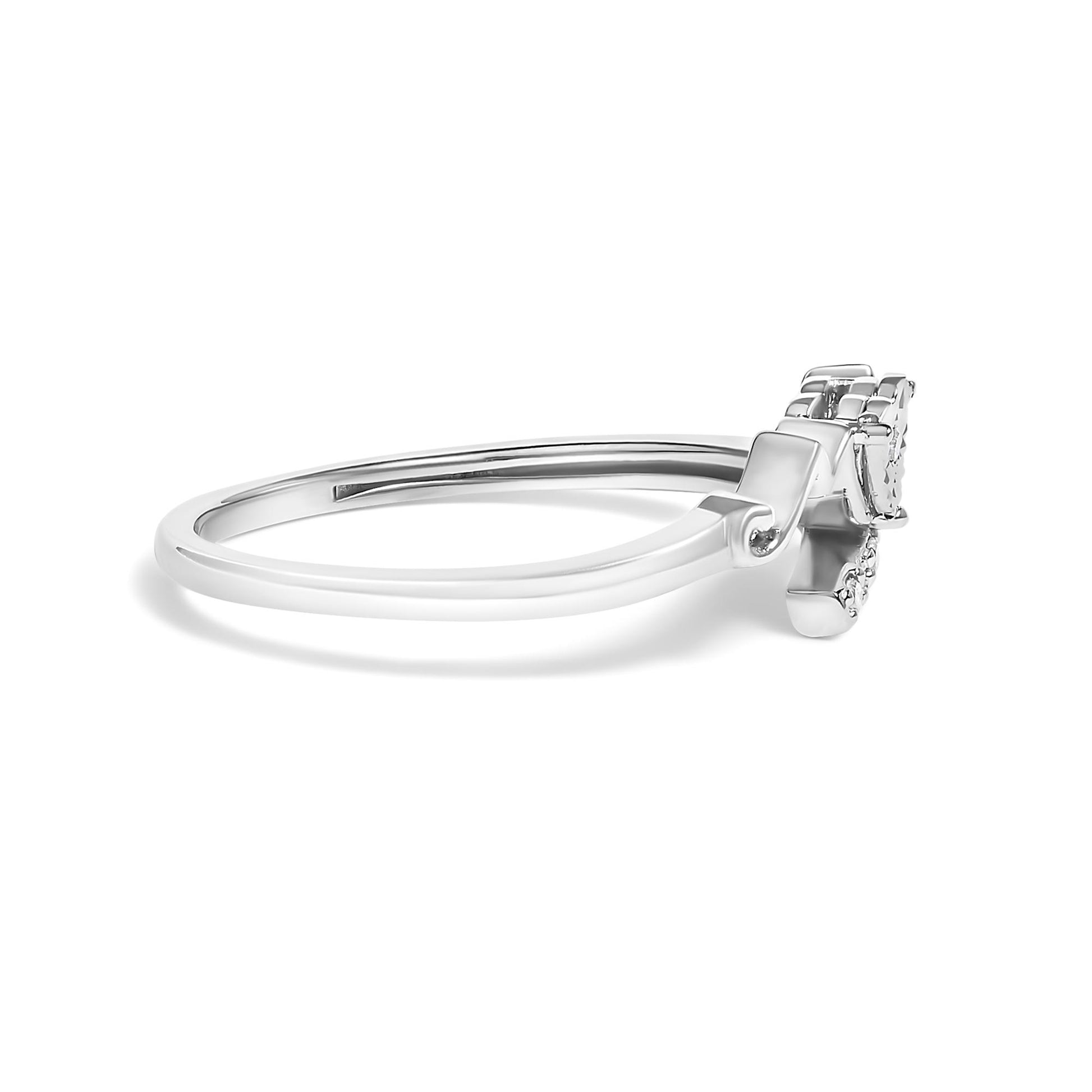 Side angle of a white metal ring with four round white gemstones in prong setting.