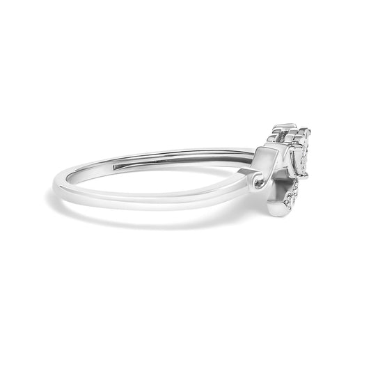 Side angle of a white metal ring with four round white gemstones in prong setting.