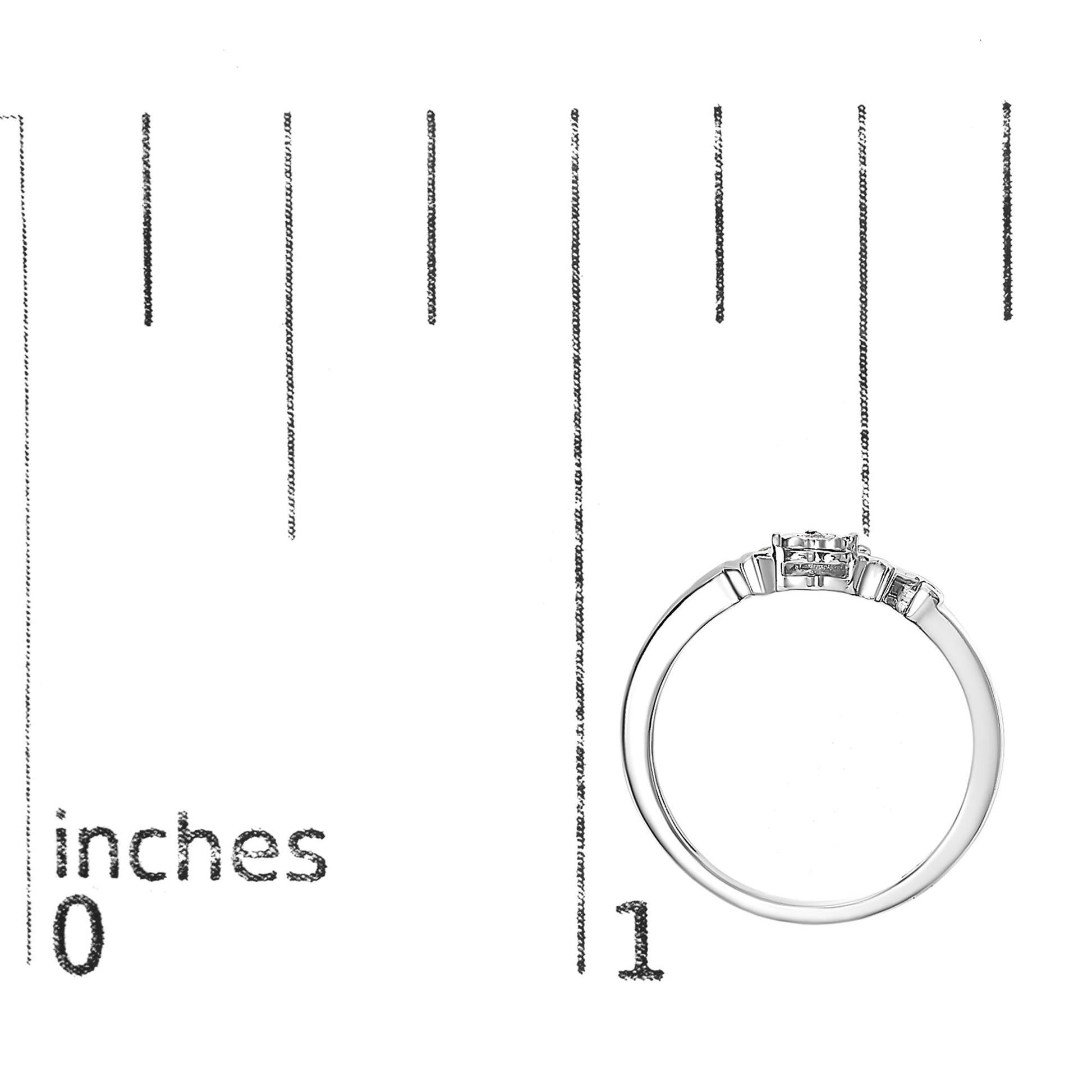White metal ring with four round white gemstones in prong settings, shown from the side on a ruler for size reference.