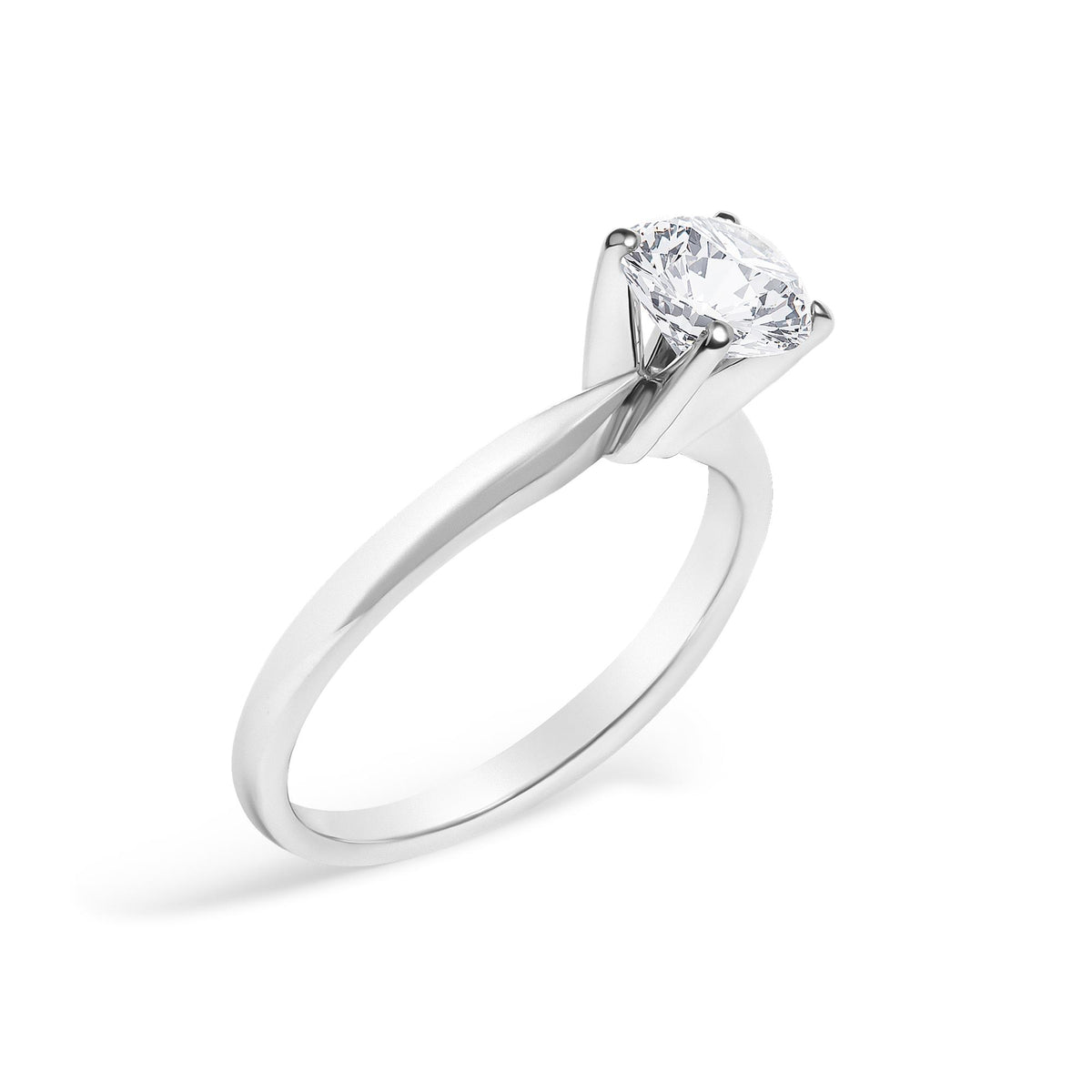 Close-up angled shot of a white metal ring with a round white gemstone set in a 4-prong setting.