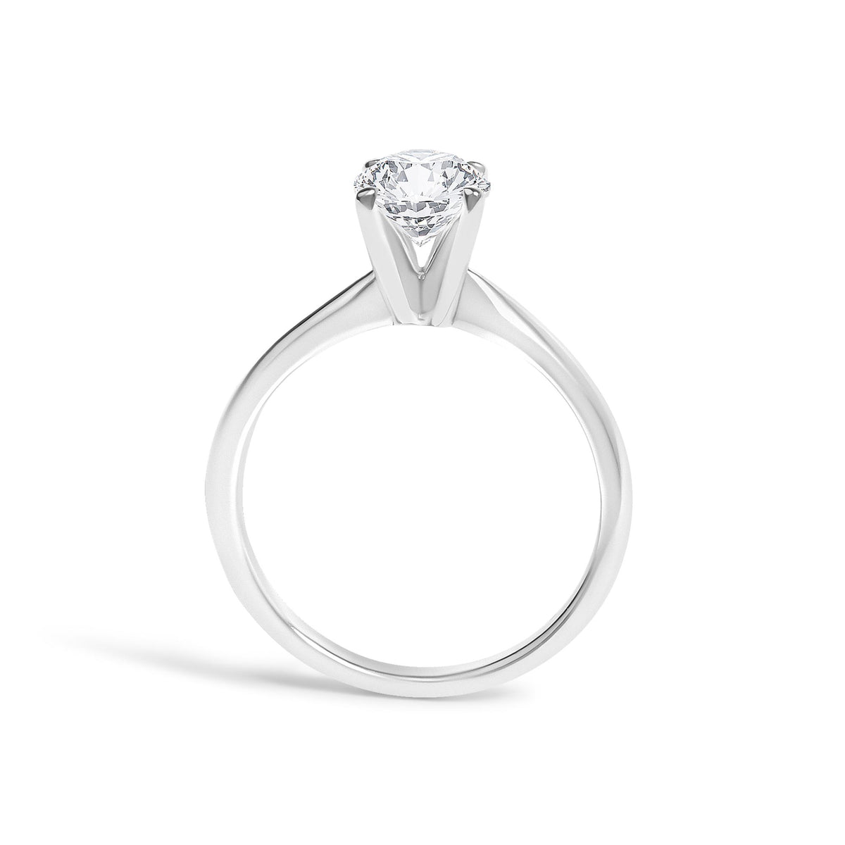 Close-up front angle of a white metal ring with a single round white gemstone set in a four-prong setting.
