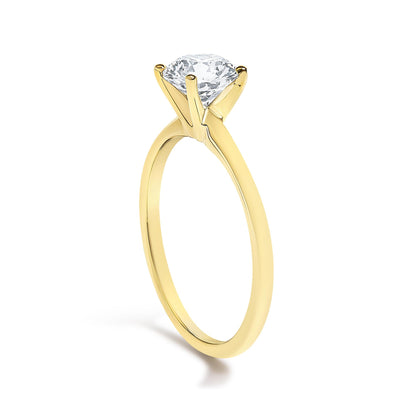 Yellow ring with a round white gemstone in a four-prong setting, shown at an angle on a white background.