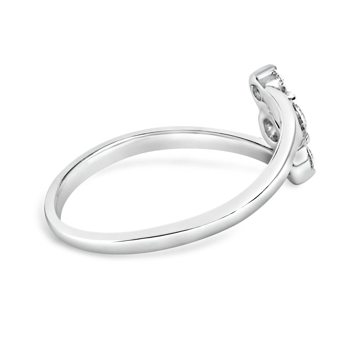 Side view of a white metal ring with a curved band holding one round white gemstone and two round white gemstones in shared prong settings.