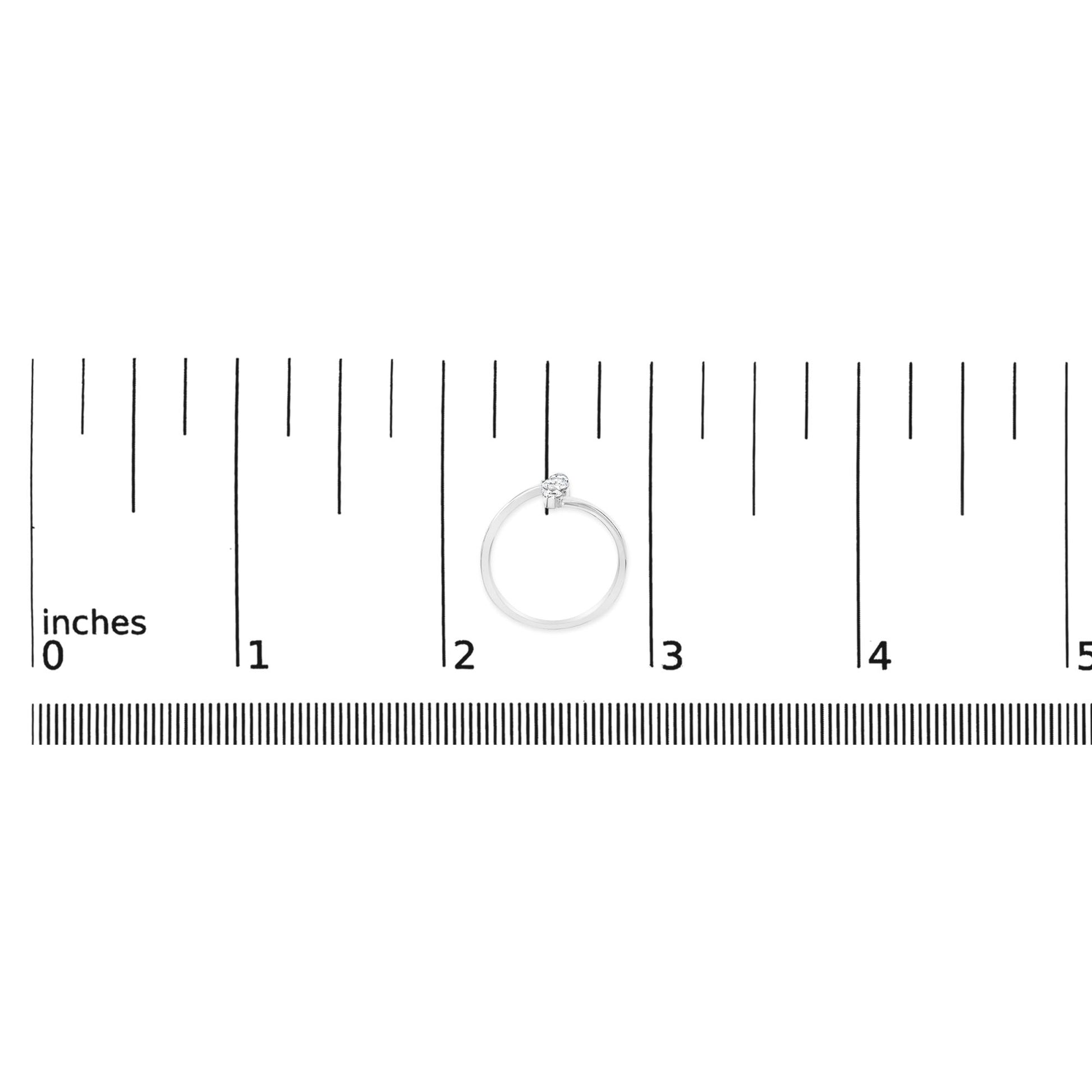 White metal ring with one round white gemstone and two round white gemstones in shared prong settings, shown on a ruler scale from a top-down angle.