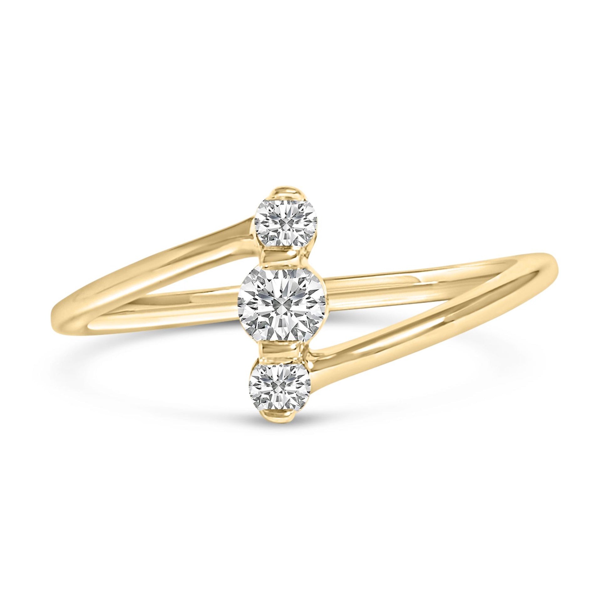 Yellow metal ring with a split band, featuring three round white gemstones in shared prong settings, shown in a front angled close-up.