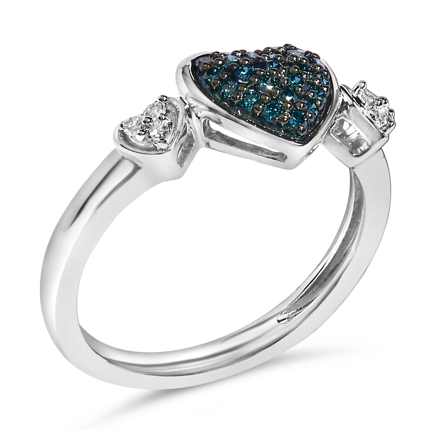 White metal ring shown at an angle with three heart-shaped settings; the center heart is filled with multiple round blue gemstones in prong settings, flanked by smaller hearts with round white gemstones in prong settings.