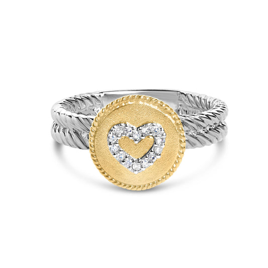 Close-up front angle of a ring with a twisted white band and a round yellow disc top featuring a heart shape outlined with small white gemstones in a shared prong setting.