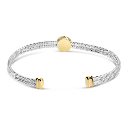 Bracelet with twisted white metal band and yellow metal accents, shown from front angle.