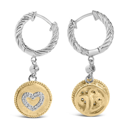 Front and back view of round white and yellow metal hoop earrings with a twisted design and a dangling disc featuring a heart shape outlined with white gemstones, shown on a white background.