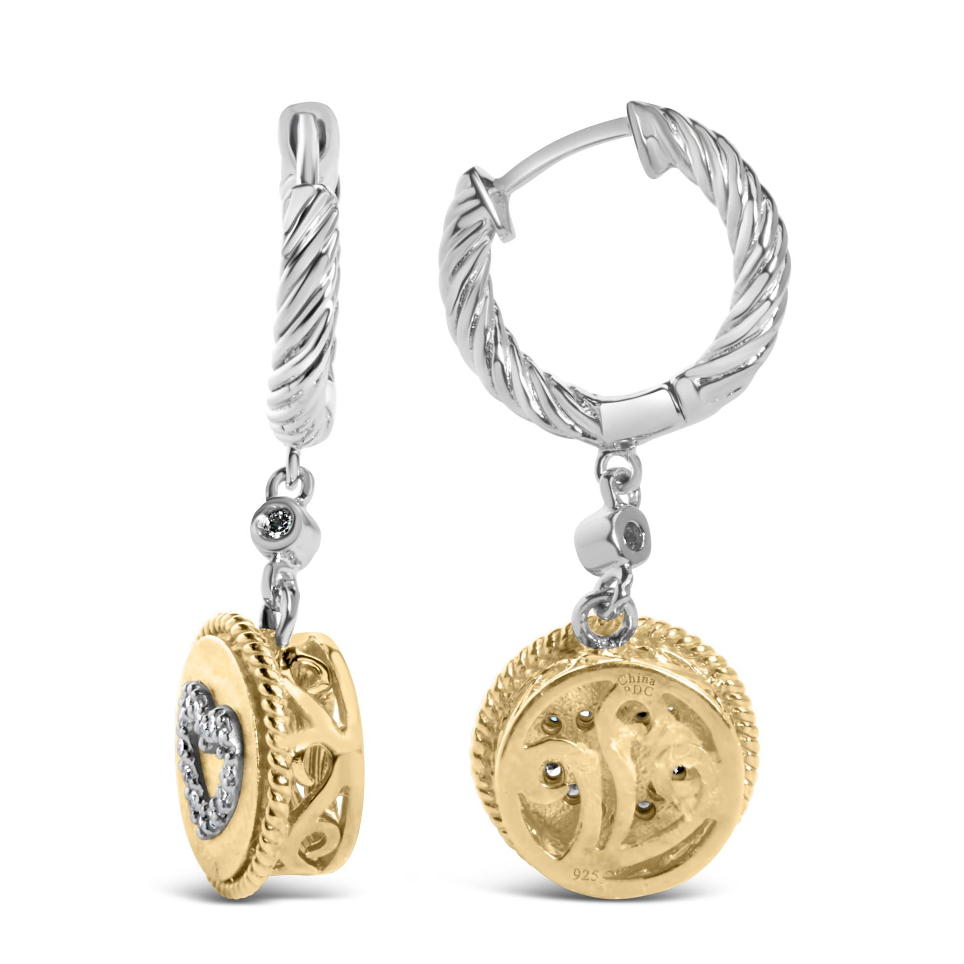 Pair of two-tone hoop earrings shown from front and side angles, featuring twisted white metal hoops with dangling yellow metal round pendants adorned with a heart of white gemstones and detailed filigree.