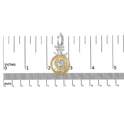 Earring pendant with yellow and white metal featuring a heart-shaped design with white gemstones, shown on a ruler for size reference, front-facing angle.