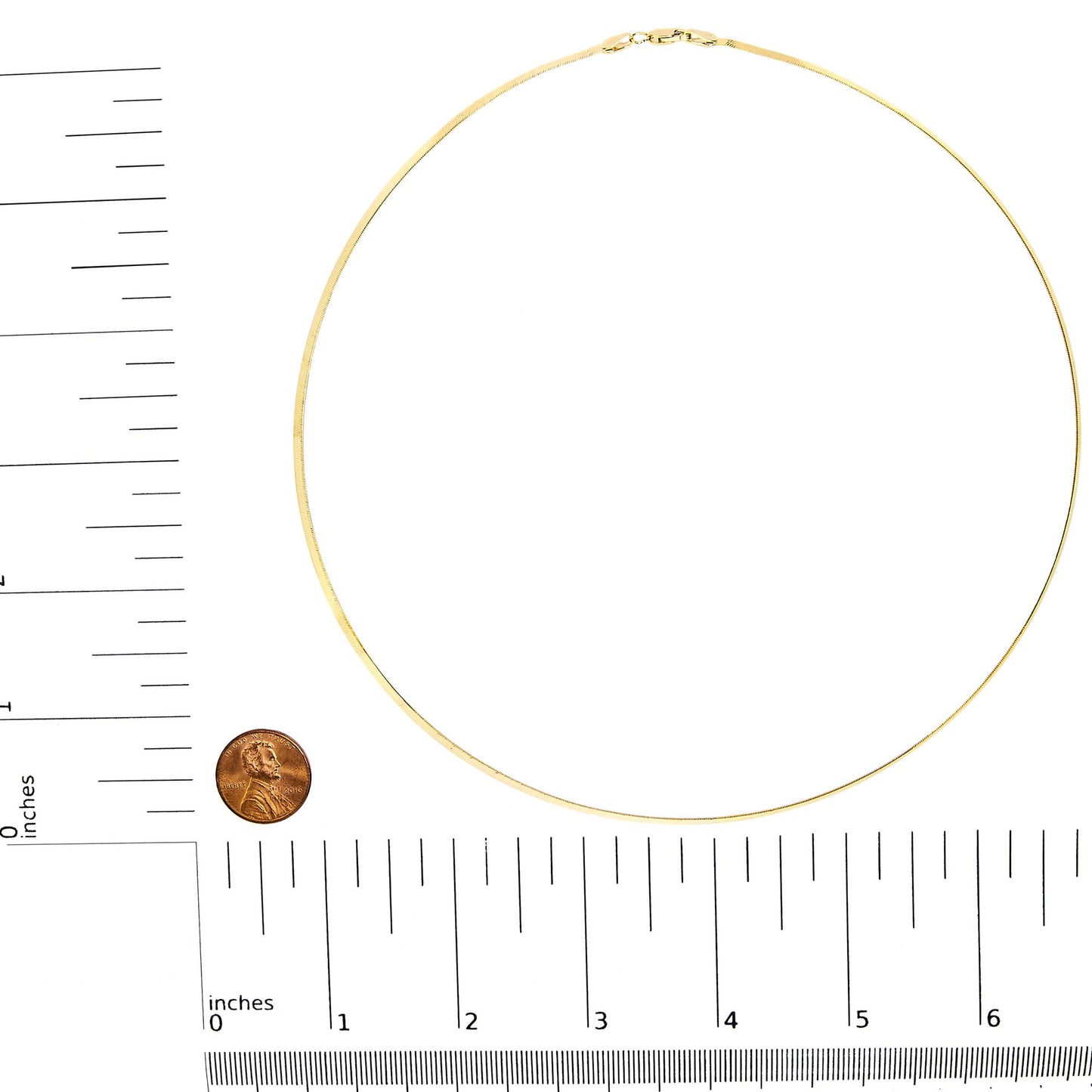 Top-down view of a yellow chain necklace placed on rulers for size reference.