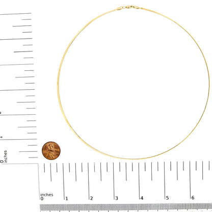 Top-down view of a yellow chain necklace placed on rulers for size reference.