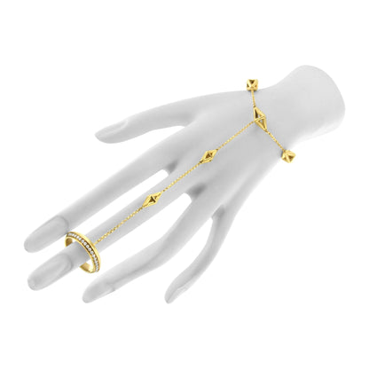Yellow metal bracelet with geometric shapes and a row of white gemstones in pave setting, shown worn on a hand model, angled from above.