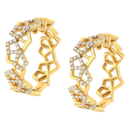 Close-up front angle of a pair of yellow metal hoop earrings with an openwork geometric pattern accented by white round pavé-set gemstones.
