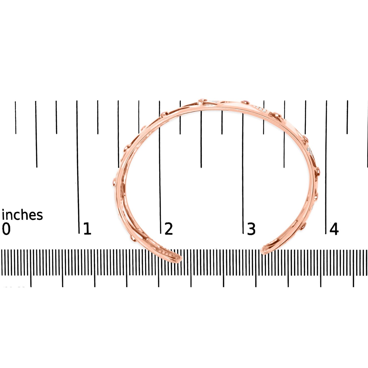 Rose metal open cuff bracelet with round pink bezel-set gemstones and white pave-set gemstones, shown from top angle on a ruler for size reference.