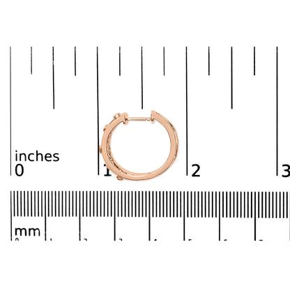 14K rose gold geometric hoop earrings shown with a scale reference