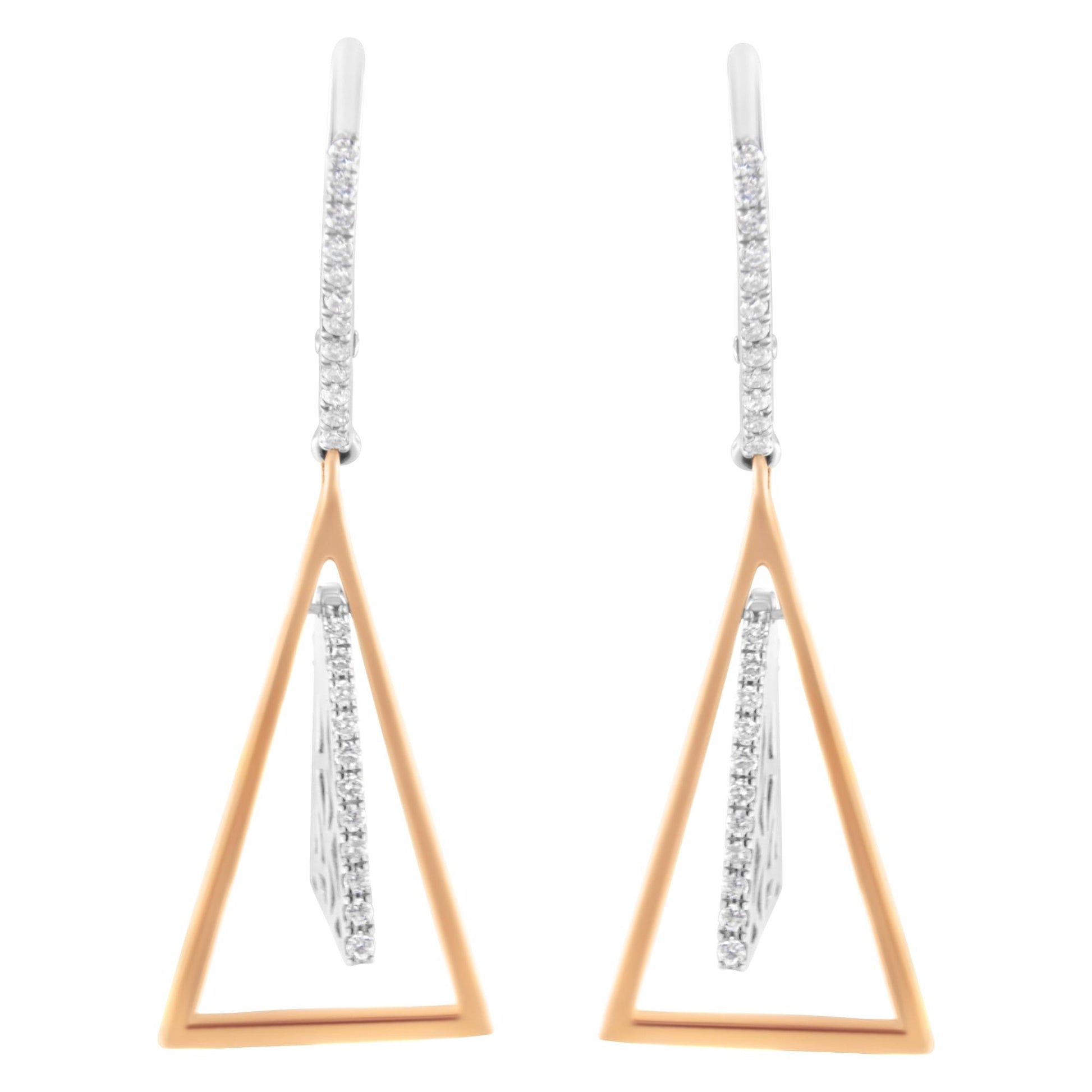 Front view of white and rose metal earrings with a triangular open frame design and white gemstones in a pave setting along the edges.