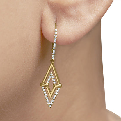 Close-up side angle of a yellow metal earring worn on a model's ear, featuring a vertical bar with white round pave-set gemstones and a geometric diamond-shaped pendant outlined with white round pave-set gemstones and a smooth inner frame.