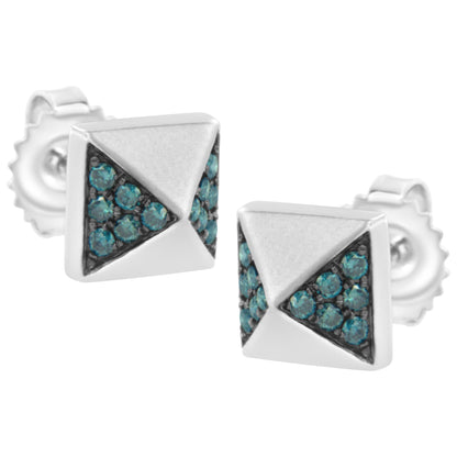 Pair of white metal square stud earrings with pyramid design featuring clusters of round blue gemstones in prong settings, shown in a close-up angled front view.