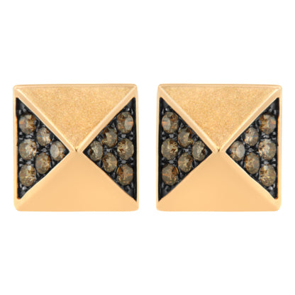 Front angle close-up of a pair of rose metal square stud earrings featuring triangular sections set with round brown gemstones.