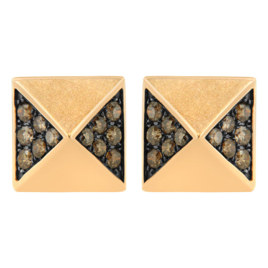 Front angle close-up of a pair of rose metal square stud earrings featuring triangular sections set with round brown gemstones.