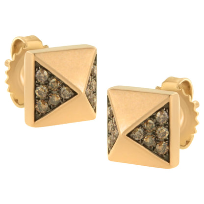 Close-up front angle of rose-colored square stud earrings with triangular sections set with round brown gemstones.