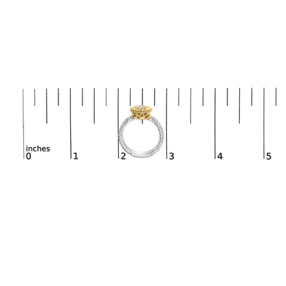Ring with a twisted white metal band and a yellow metal circular top set with round white gemstones, shown from the side on a ruler for size reference.