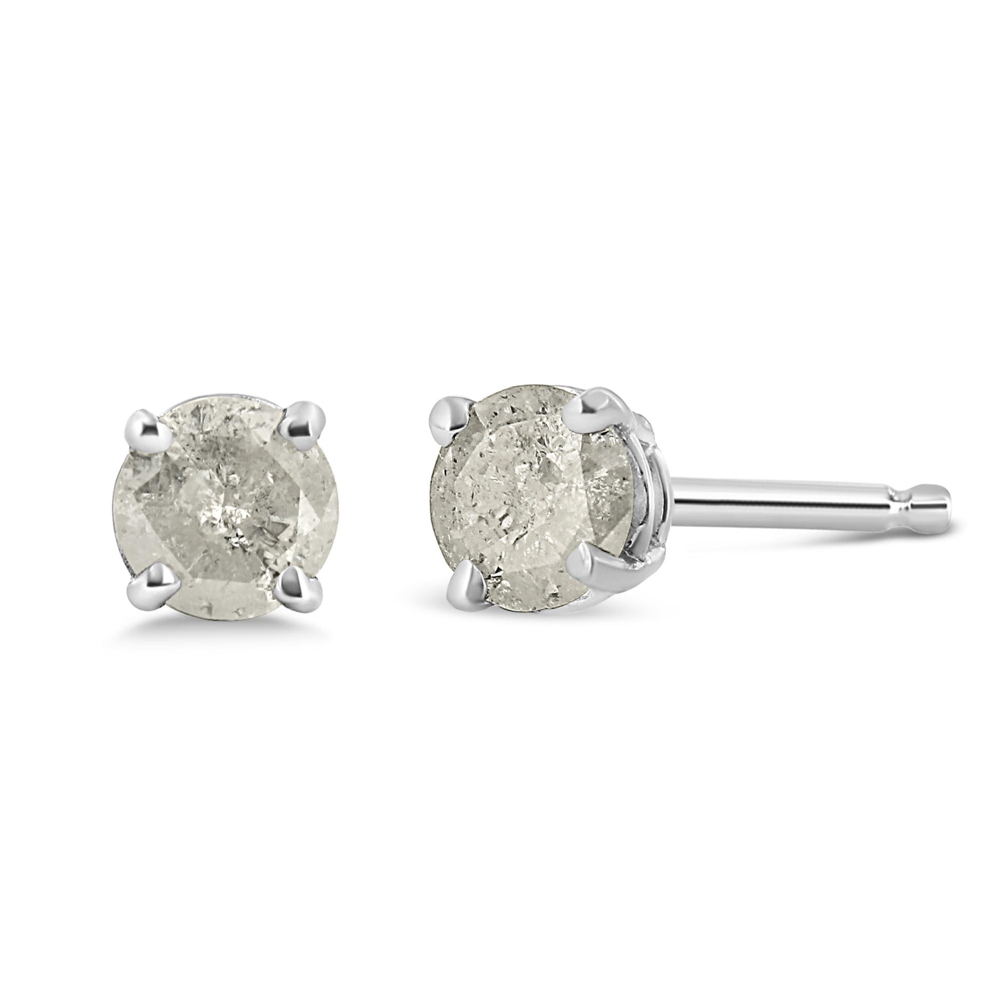 Front and side angle of white metal stud earrings each featuring a round white gemstone in prong setting.