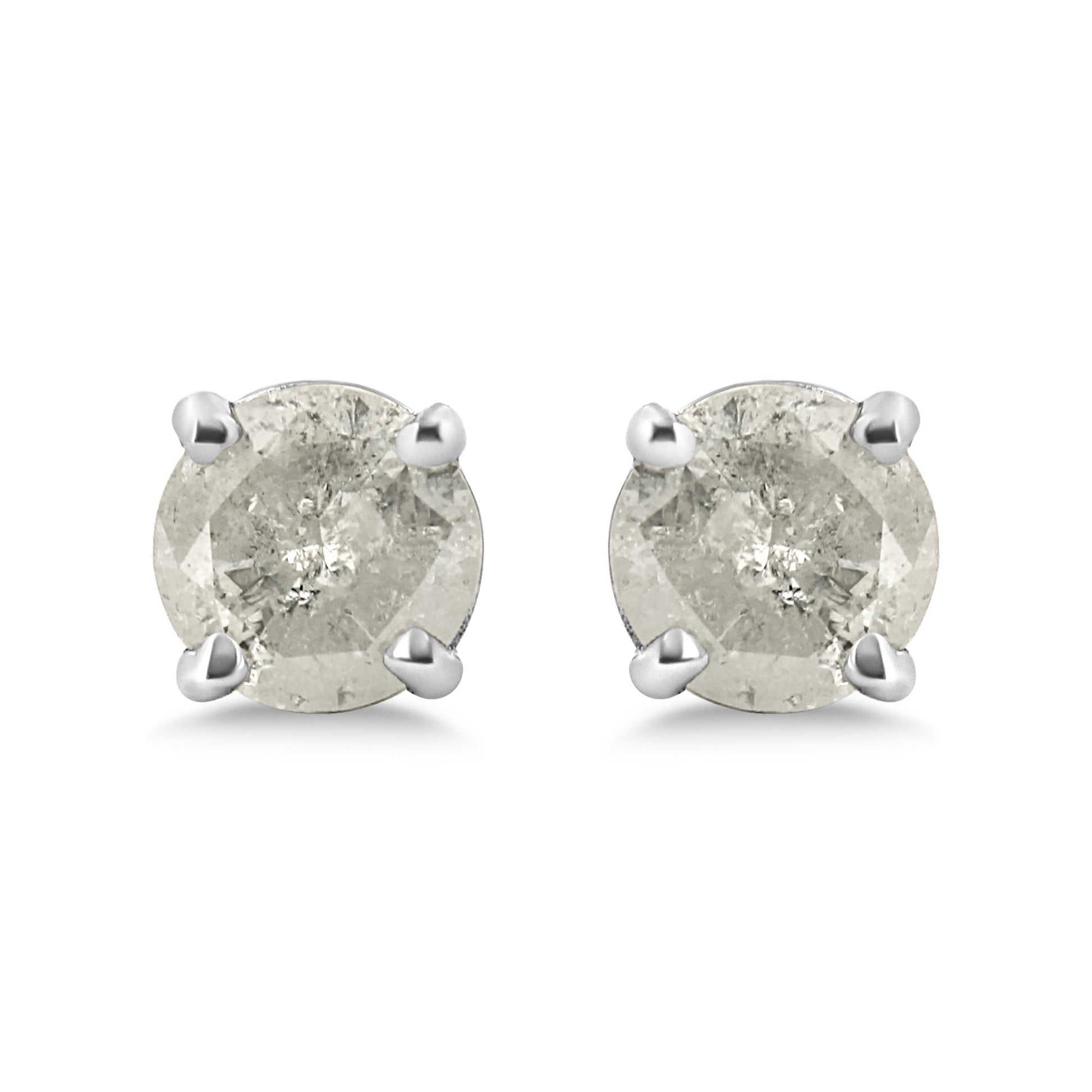 Front view of a pair of white metal stud earrings with round white gemstones in prong settings.
