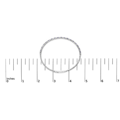 White bracelet with alternating blue and white round gemstones in prong settings, shown flat on a ruler scale, top-down view.